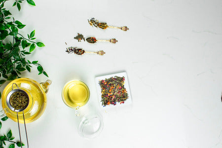 Herbal tea glass and tea leaves in bowls